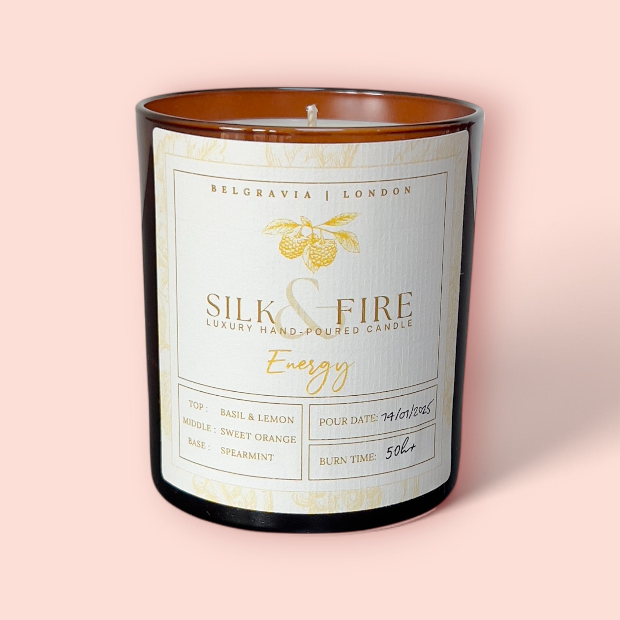 Silk & Fire Energy Aromatherapy Candle in an amber glass jar, featuring an uplifting blend of citrus and herbal essential oils. Made with hand-poured coconut & rapeseed wax in London for a revitalising, non-toxic burn.